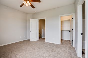 Carpeted Bedroom Featuring Two Walk-In Closets